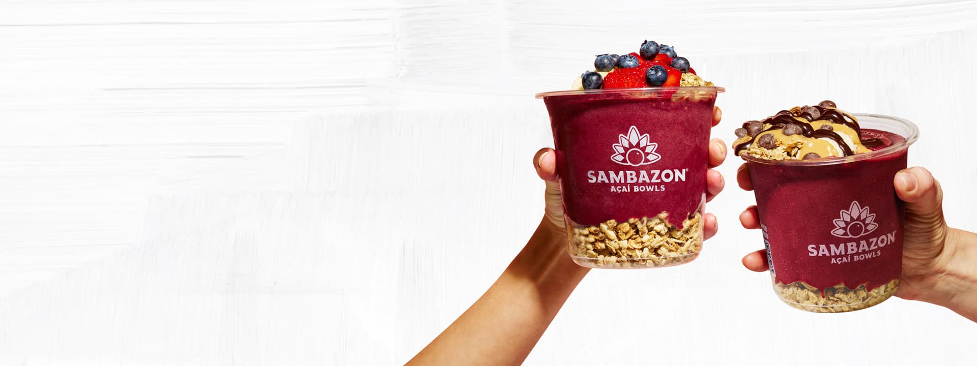 Two SAMBAZON Acai Bowls Saying a Cheers